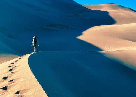 Hiker wandering on sand dunes